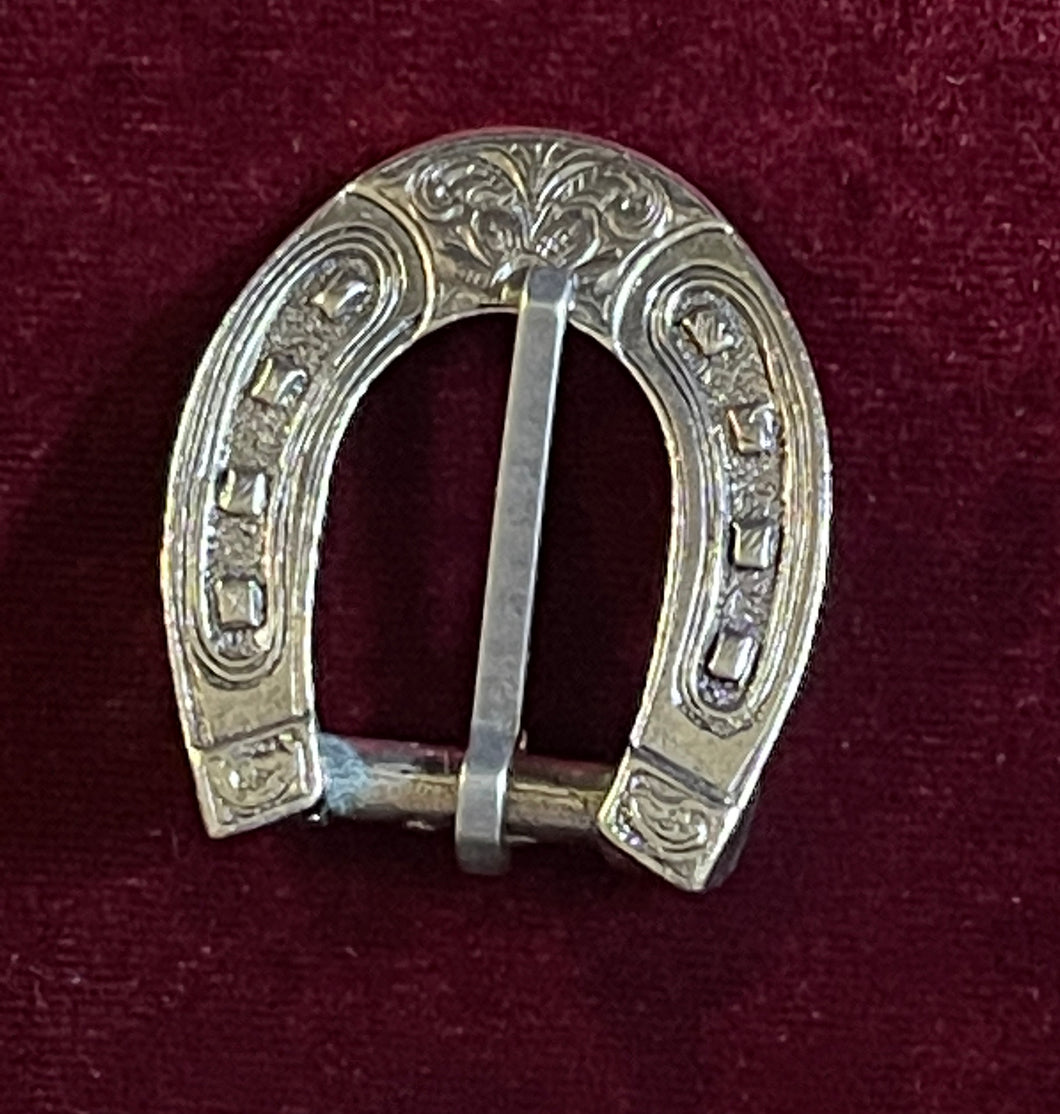 Silver horseshoe buckle, engraved with nail details.